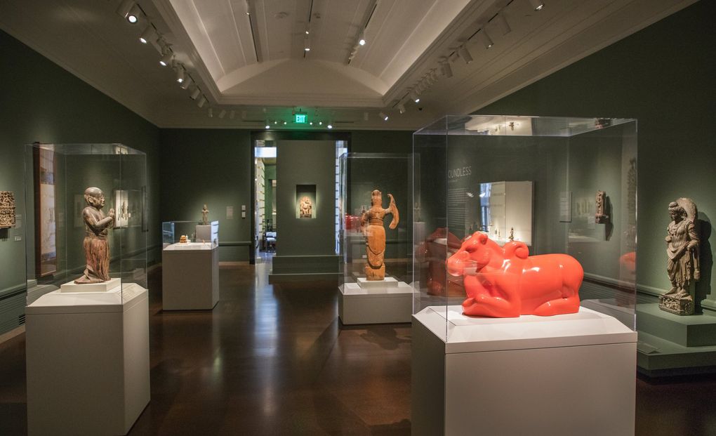 The orange, extruded-fiberglass “Nandi” brightly punctuates Seattle Asian Art Museum’s “Spiritual Journeys” gallery, which is full of stone, wood and other visually muted materials. (Steve Ringman / The Seattle Times)