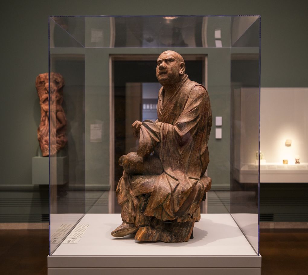 The Dragon Tamer Luohan, which had long been misidentified as a monk at the moment of enlightenment, stands in the “Bringing Blessings” gallery at Seattle Asian Art Museum. (Steve Ringman / The Seattle Times)