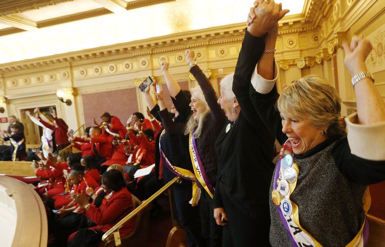 Equal Rights Amendment supporter Donna Granski, right, from Midlothian Va., cheers the passage of the House ERA Resolution in the Senate chambers at the Capitol in Richmond, Va. Monday, Jan. 27, 2020. The resolution passed 27-12. (AP Photo/Steve Helber) VASH104 VASH104