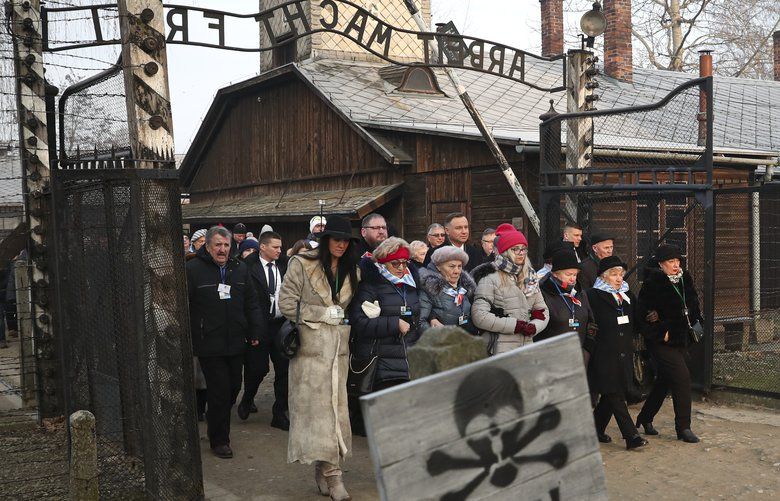 Poland’s President Andrzej Duda walks along with survivors through the gates of the Auschwitz Nazi concentration camp to attend the 75th anniversary of its liberation in Oswiecim, Poland, Monday, Jan. 27, 2020. (AP Photo/Czarek Sokolowski) XVG101 XVG101