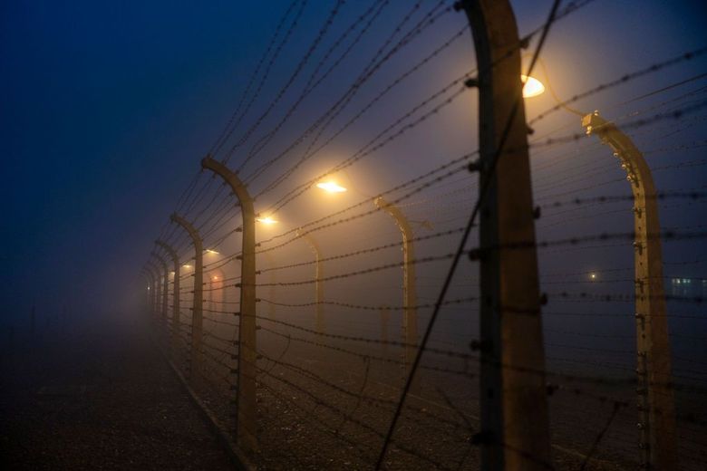 OSWIECIM, POLAND – DECEMBER 19: A morning fog blankets the electric fence and security lights that surround the Auschwitz I extermination camp on December 18, 2019 in Oswiecim, Poland. Ceremonies marking the 75th anniversary of the liberation of the camp by Soviet soldiers are due to take place on January 27, 2020. Auschwitz was a network of concentration camps built and operated in occupied Poland by Nazi Germany during the Second World War. Auschwitz I and nearby Auschwitz II-Birkenau was the extermination camp where an estimated 1.1 million people, mostly Jews from across Europe, were killed in gas chambers or from systematic starvation, forced labour, disease and medical experiments. (Photo by Christopher Furlong/Getty Images) (Photographer: Christopher Furlong/Getty Images Europe)