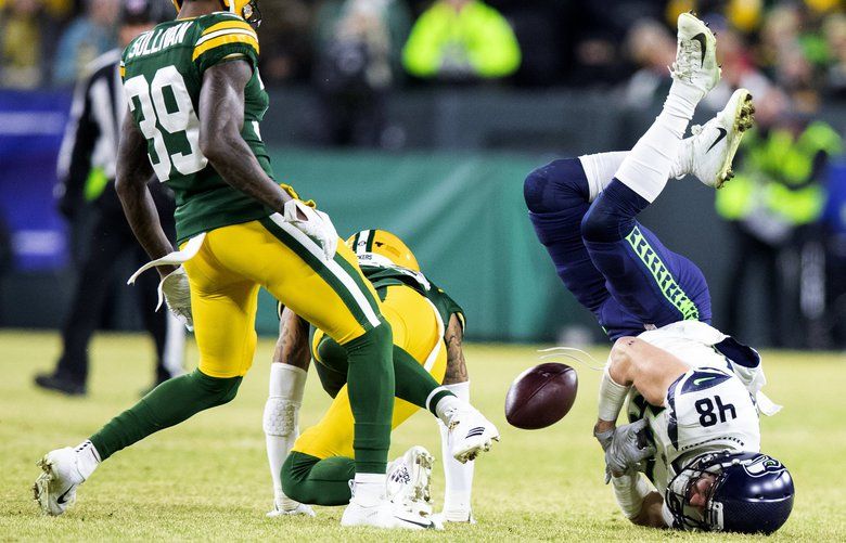 Packers quarterback Aaron Rodgers alerts the ref to a face mask call after  getting sacked during the 1st half of Green Bay's NFL game against the  Seattle Seahawks in Seattle, Washington, Monday