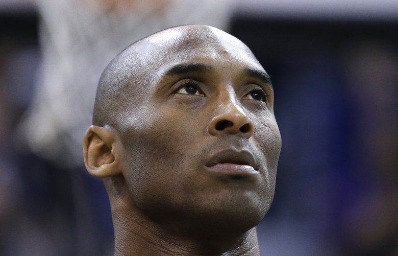FILE – In this March 28, 2016, file photo, Los Angeles Lakers forward Kobe Bryant looks on before the start of their NBA basketball game against the Utah Jazz, in Salt Lake City. Bryant, the 18-time NBA All-Star who won five championships and became one of the greatest basketball players of his generation during a 20-year career with the Los Angeles Lakers, died in a helicopter crash Sunday, Jan. 26, 2020. (AP Photo/Rick Bowmer, File) UTRB105 UTRB105