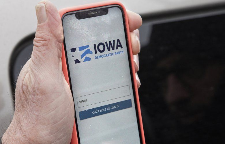 Precinct captain Carl Voss of Des Moines displays the Iowa Democratic Party caucus reporting app on his phone outside of the Iowa Democratic Party headquarters in Des Moines, Iowa, Tuesday, Feb. 4, 2020. (AP Photo/Nati Harnik) IANH109 IANH109