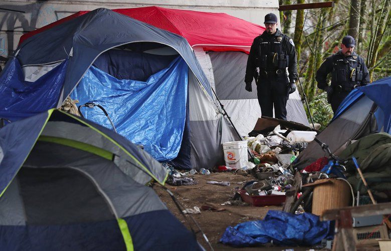 The homeless encampment under the 4th Avenue Olympia Yashiro Friendship Bridge, seen just after police, pictured, posted that the area would be swept, Tuesday, Jan. 21, 2020 in Olympia. 212722