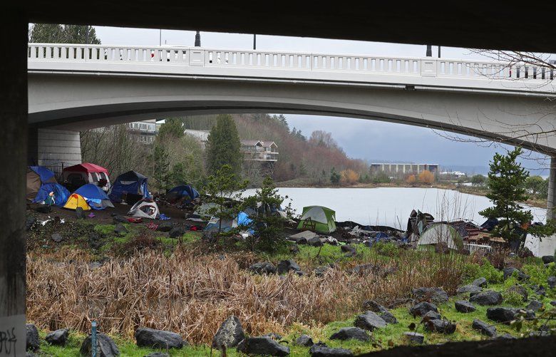 The homeless encampment under the 4th Avenue Olympia Yashiro Friendship Bridge, is seen just after police posted that the area would be swept, Tuesday, Jan. 21, 2020 in Olympia. 212722