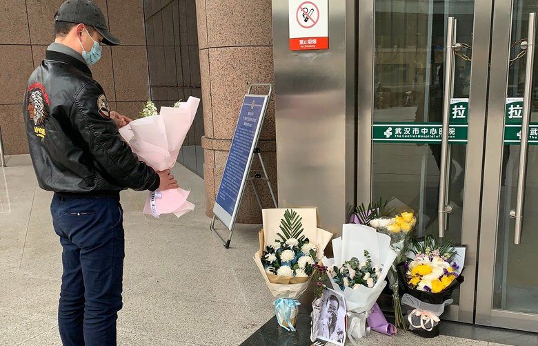 A person stands next to a makeshift memorial for Dr. Li Wenliang at Wuhan City Central Hospital in China, on Feb. 7, 2020. The Chinese public have staged what amounts to an online revolt after the death of Wenliang, who tried to warn of a mysterious virus that has since killed hundreds of people in China, infected tens of thousands and forced the government to corral many of the country’s 1.4 billion people. (Chris Buckley/The New York Times) XNYT24 XNYT24