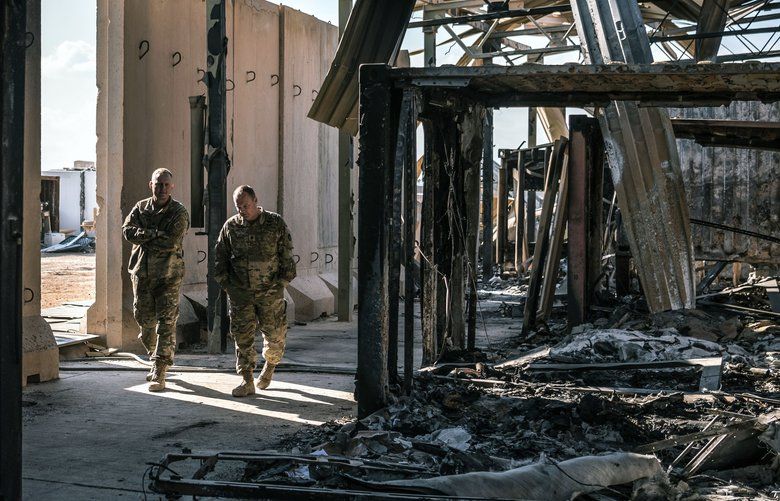 FILE — U.S. military personnel survey the damage to a building that was struck by Iranian missiles at Al Asad Air Base in Anbar, Iraq, Jan. 13, 2020. Trump on Jan. 22 dismissed concussion symptoms reported by several American troops after Iranian airstrikes on Al Asad Air Base as “not very serious,” even as the Pentagon acknowledged that a number of service members were being examined for possible traumatic brain injury caused by the attack. (Sergey Ponomarev/The New York Times)  XNYT177 XNYT177