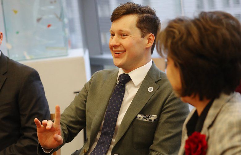 Newly sworn-in Seattle City Council member Andrew Lewis, center, is seen with his staff policy lead Jacob Thorpe, left, and Monica Martinez Simmons, the City Clerk, right, during an orientation meeting for new members, Thursday, Jan. 2, 2020, at Seattle City Hall. 212535