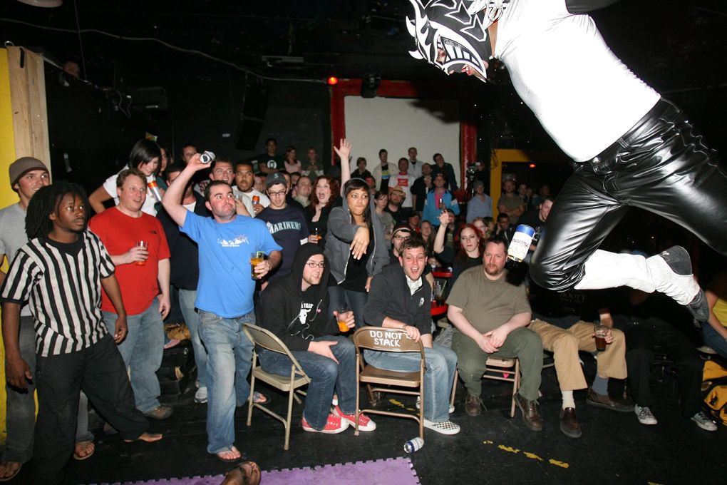In a semi-pro wrestling match at Re-bar in 2007, Eric Hendrickson, aka Histeria, takes flight as he sails down to the floor, where his opponent is waiting for his body blow. (Steve Ringman / The Seattle Times)