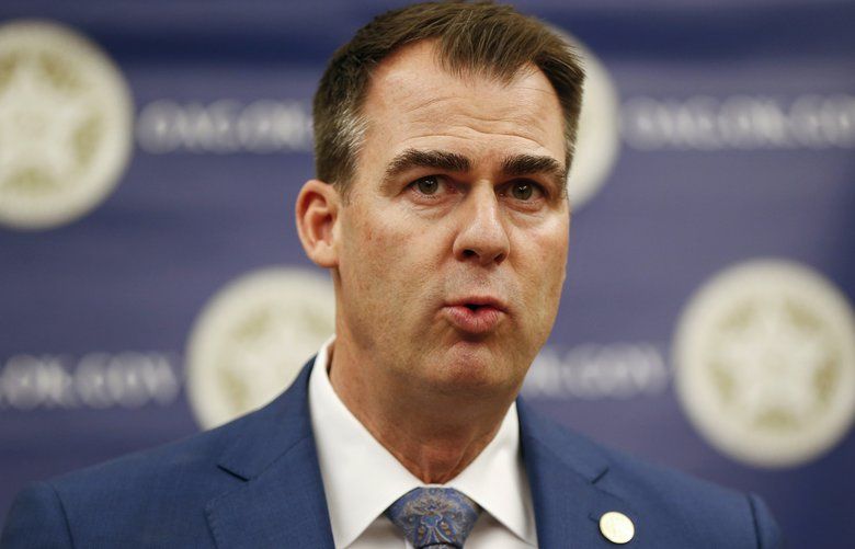 FILE – In this Feb. 13, 2020, file photo, Oklahoma Gov. Kevin Stitt speaks during a news conference in Oklahoma City, Okla. A state panel led by Gov. Stitt certified on Tuesday, Feb. 18, 2020, a relatively flat budget for the upcoming fiscal year, and the governor is urging the Legislature to use caution while drafting a state spending plan. (Nate Billings/The Oklahoman via AP File0 OKOKL101 OKOKL101