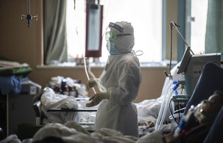 In this Saturday, Feb. 22, 2020, photo released by Xinhua News Agency, a nurse works at an ICU ward specialised for patients infected by coronavirus in Wuhan in central China’s Hubei Province. Warning that China’s virus epidemic is “still grim and complex,” President Xi Jinping called Sunday, Feb. 23, 2020 for more efforts to stop the outbreak, revive industry and prevent the disease from disrupting spring planting of crops. (Xiao Yijiu/Xinhua via AP) XIN802