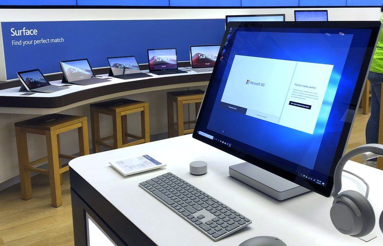 FILE – In this Jan. 28, 2020, file photo a Microsoft computer is among items displayed at a Microsoft store in suburban Boston. Microsoft says its supply chain is being hurt by the virus outbreak in China and will return to normal operations at a slower pace than it expected a month ago. (AP Photo/Steven Senne, File) NYBZ399 NYBZ399