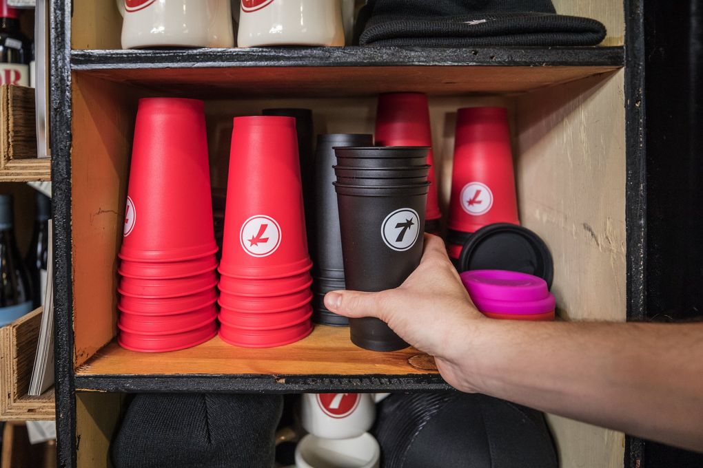 Seven Coffee Roasters Market & Cafe sells reusable cups at cost, along with paper cups for 10 cents. (Steve Ringman / The Seattle Times)