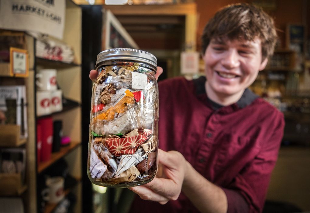 Jacob Huskey, sustainability and marketing specialist at Seven Coffee Roasters, shows off the amount of trash they produced in a week in January. Everything else was recycled. (Steve Ringman / The Seattle Times)