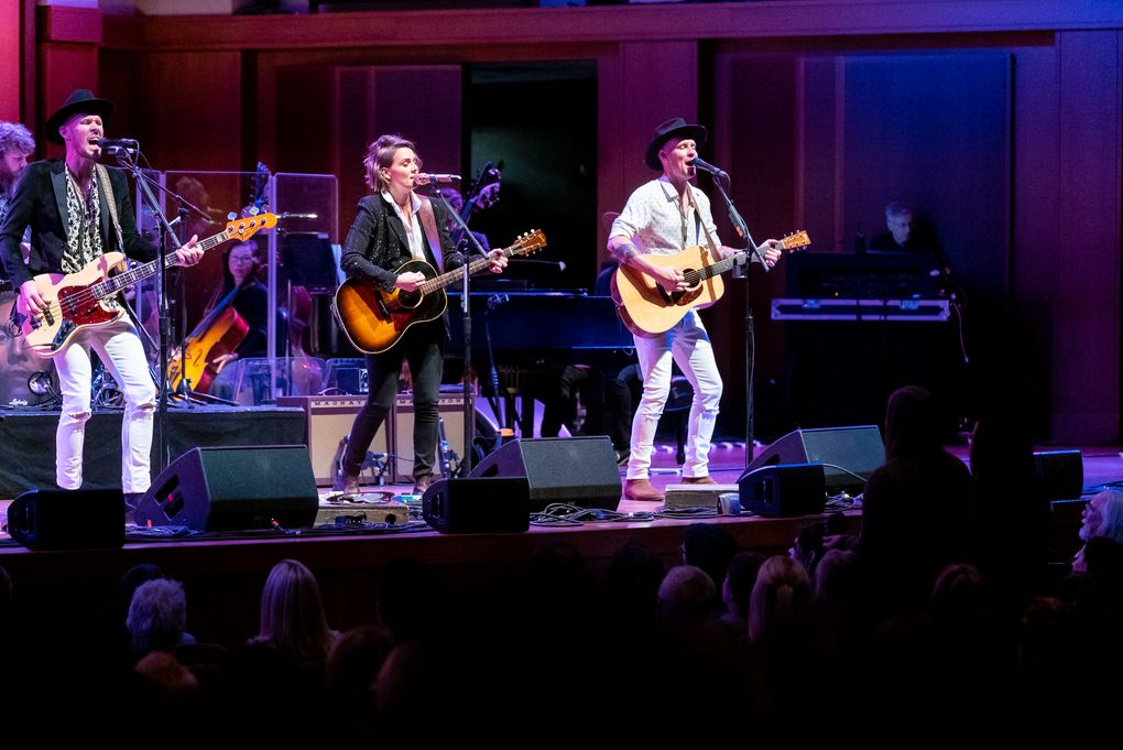 Brandi Carlile and Phil and Tim Hanseroth perform with members of the Seattle Symphony Friday. (James Holt / Seattle Symphony)