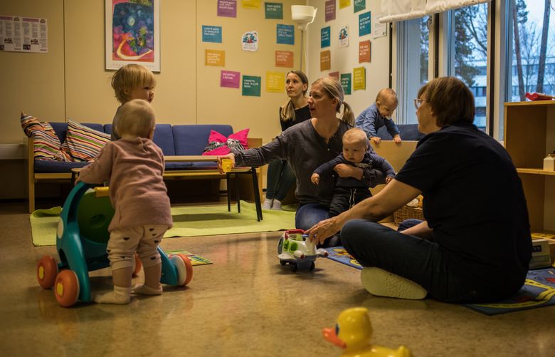 Parents and children play together at a day care center in Kauniainen, Finland. Nov. 15, 2018. In a bid to promote equality and inclusivity, parents in Finland will be given the same amount of parental leave, regardless of their gender or whether they are a child’s biological parents, its government announced in February 2020. (Lena Mucha/The New York Times)