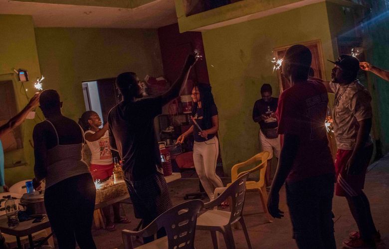 Migrants from Cameroon celebrate the birthday of a fellow asylum seeker at a bar in Tapachula, Mexico, Feb. 7, 2020. With no easy path to the U.S., migrants from around the world are settling in Mexico, creating diasporic communities with tastes of home. (Daniele Volpe/The New York Times)
