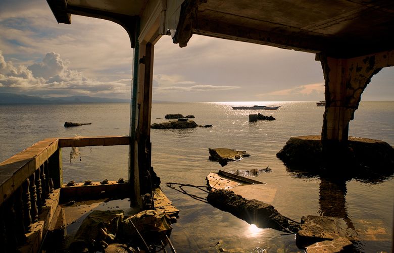 The remains of a submerged house on Batasan, an island in the Philippines, where the highest point is just 6.5 feet above sea level, Nov. 24, 2019. A 7.2-magnitude earthquake in 2013 caused Batasan and three neighboring islands to collapse downward, making them more vulnerable to the surrounding sea. (Jes Aznar/The New York Times)