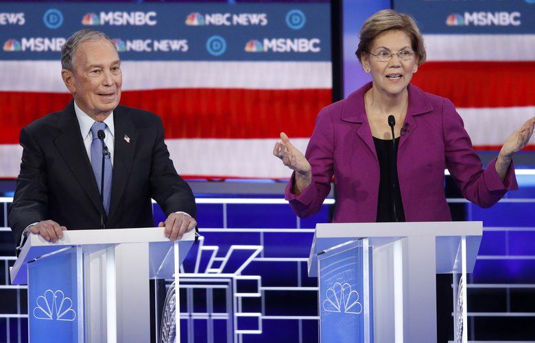 Democratic presidential candidates Sen. Elizabeth Warren, D-Mass., right, speaks as former New York City Mayor Mike Bloomberg looks on during a Democratic presidential primary debate Wednesday, Feb. 19, 2020, in Las Vegas, hosted by NBC News and MSNBC. (AP Photo/John Locher) NVCC127 NVCC127