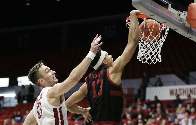 Stanford forward Oscar da Silva, right, dunks in front of Washington State forward Jeff Pollard during the first half of an NCAA college basketball game in Pullman, Wash., Sunday, Feb. 23, 2020. (AP Photo/Young Kwak) WAYK101 WAYK101