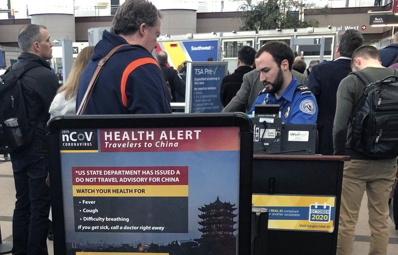 FILE – In this Monday, March 2, 2020 file photo, a health alert for people traveling to China is shown at a TSA security checkpoint at the Denver International Airport in Denver. A steep drop in business travel could be a gut punch to a tourism industry already reeling from the coronavirus outbreak, as big companies like Amazon try to keep employees healthy by banning trips.  (AP Photo/Charles Rex Arbogast, File) COCA501 COCA501
