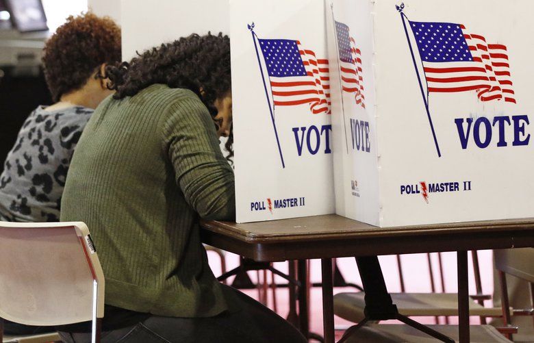 Voters work on their ballots in the kiosks in Jackson, Miss., Tuesday, March 10, 2020. Mississippi is one of several states holding presidential party primaries today. (AP Photo/Rogelio V. Solis) MSRS117 MSRS117