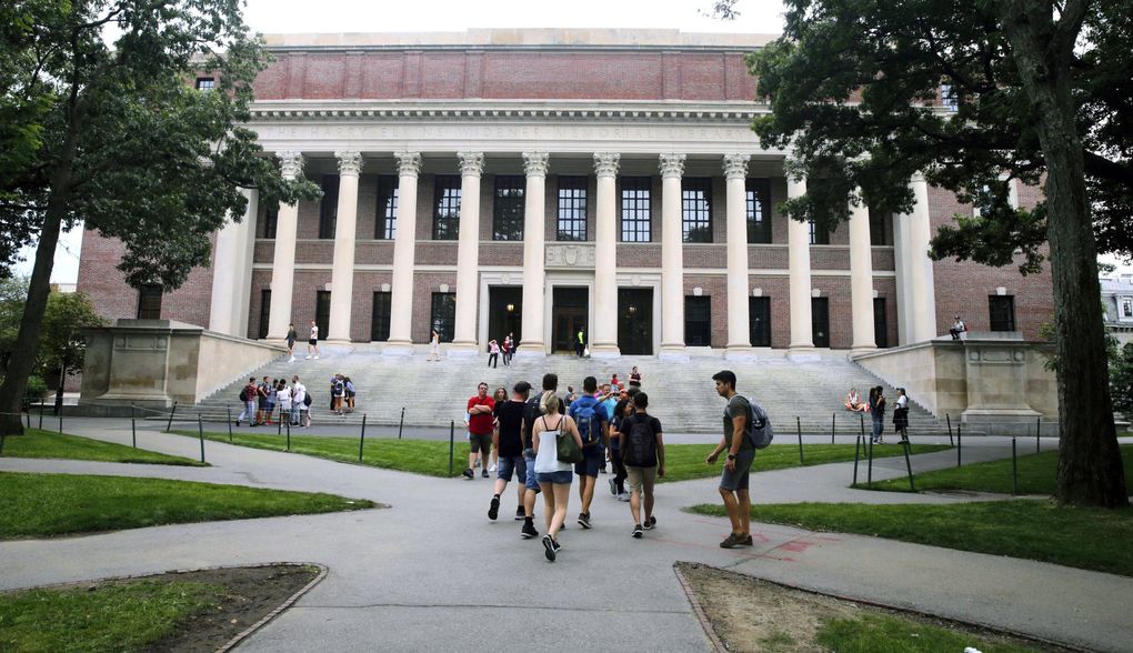 Students walk near the Widener Library in Harvard Yard. The Cambridge, Mass., institution is the latest to switch to online instruction in light of the coronavirus. (Charles Krupa / The Associated Press, 2019)