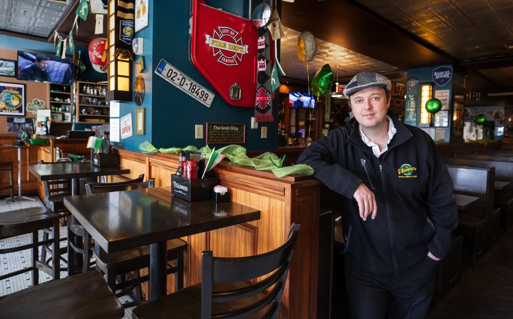 Shawn O’Donnell Jr., owner of four iterations of Shawn O’Donnell’s American Grill and Irish Pub, stands in his nearly empty Pioneer Square restaurant Thursday. He said the coronavirus scare has cut his business by 61%. (Ellen M. Banner / The Seattle Times)