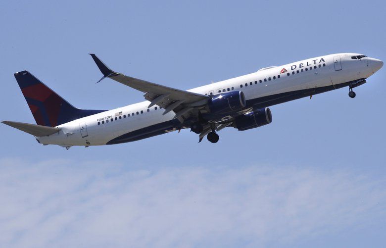 FILE- In this May 24, 2018, file photo a Delta Air Lines passenger jet plane, a Boeing 737-900 model, approaches Logan Airport in Boston. Airlines are seeing a sharp drop in bookings and a rise in cancellations in recent days as the coronavirus outbreak continues to spread, and they are responding by slashing flights and freezing hiring. Normally airlines try to lure reluctant customers by discounting fares, but that won’t work in the face of the COVID-19 outbreak. (AP Photo/Charles Krupa, File) NY110 NY110