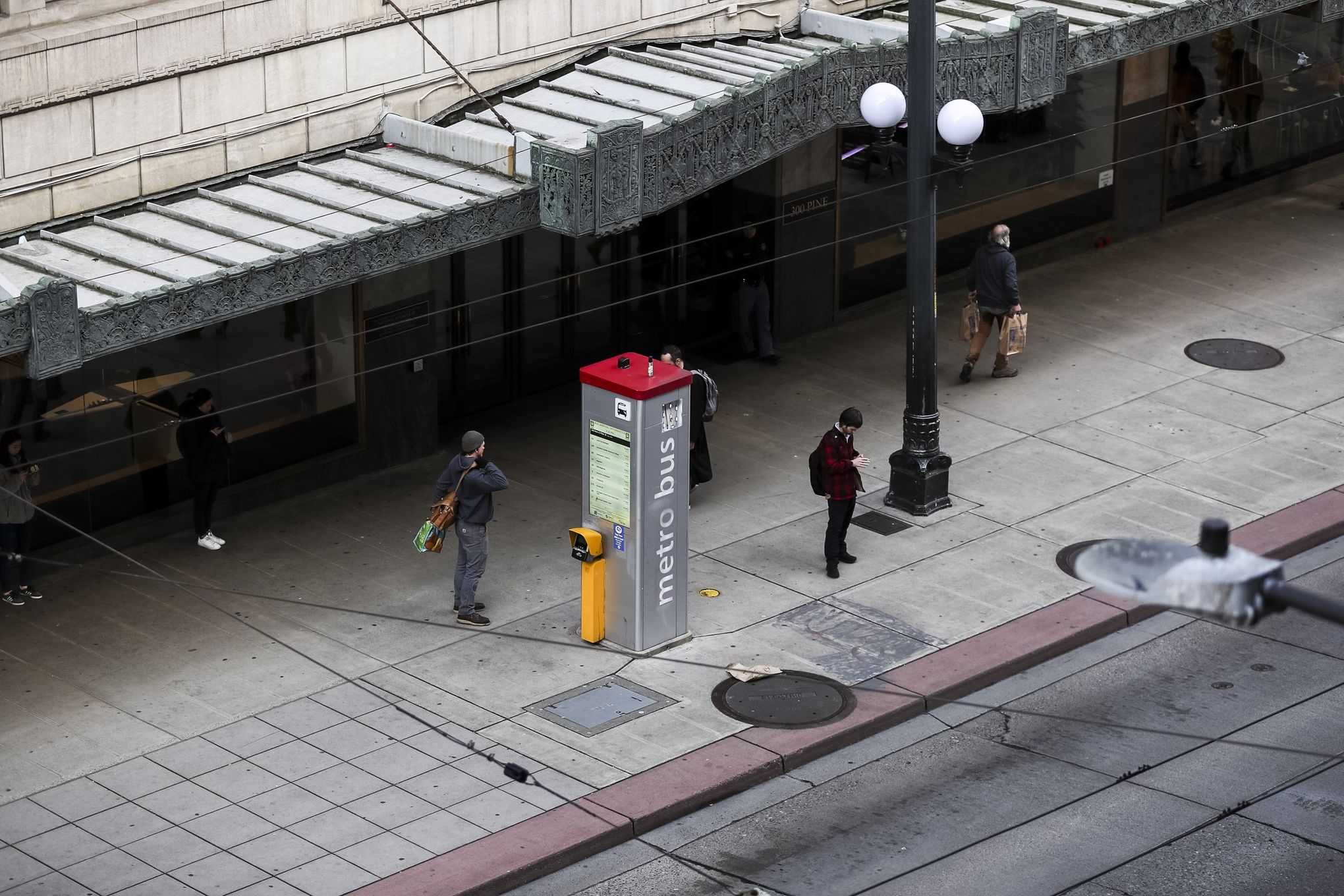 A passerby looks to the Apple Store now closed until March 27th at