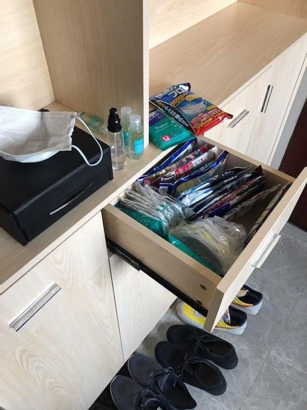 Pat Loney’s “drawer of pandemic goodies” near his front door in Shenzhen, China, including face masks, plus alcohol gels, sprays and wipes. (Pat Loney / For The Seattle Times)