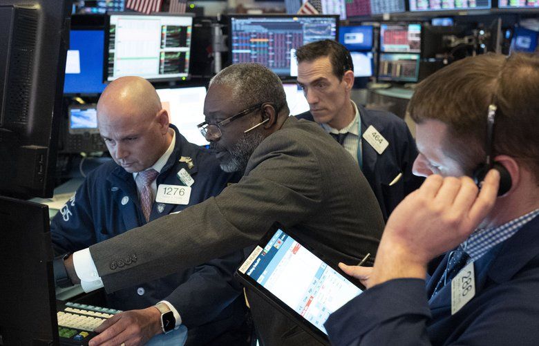 Traders at the New York Stock Exchange work as the market closes, Wednesday, March 18, 2020 in New York. (AP Photo/Mark Lennihan) NYML113 NYML113