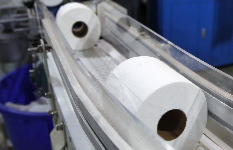 Toilet paper moves out from a cutting machine at the Tissue Plus factory, Wednesday, March 18, 2020, in Bangor, Maine. The new company has been unexpectedly busy because of the shortage of toilet paper brought on by hoarders concerned about the coronavirus. (AP Photo/Robert F. Bukaty) MERB203 MERB203