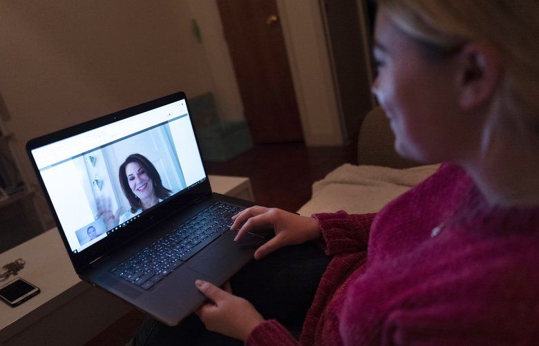 FILE – In this Jan. 14, 2019 photo, a patient sits in the living room of her apartment in the Brooklyn borough of New York during a telemedicine video conference with Dr. Deborah Mulligan. Telemedicine often involves diagnosing and treating a new health problem but is also used to keep tabs on an existing, long-term condition. (AP Photo/Mark Lennihan) NY710 NY710