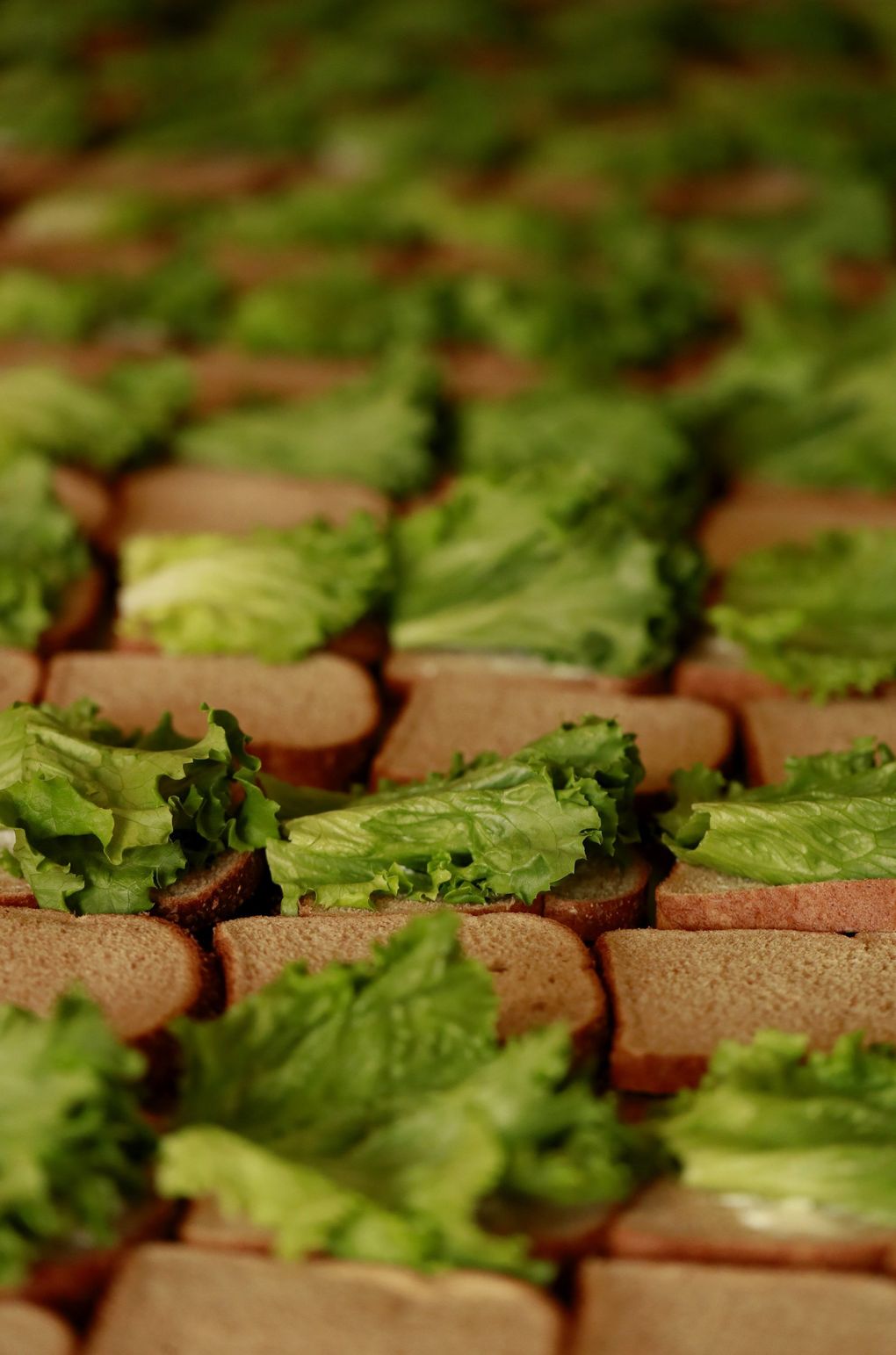 When Javier Hernández lost shifts at the Meydenbauer Center in Bellevue, he decided to focus his efforts on providing sandwiches and supplies to those who may need it most. He makes sandwiches for schoolchildren at Frelard Tamales, where his son is a co-owner. (Erika Schultz / The Seattle Times)