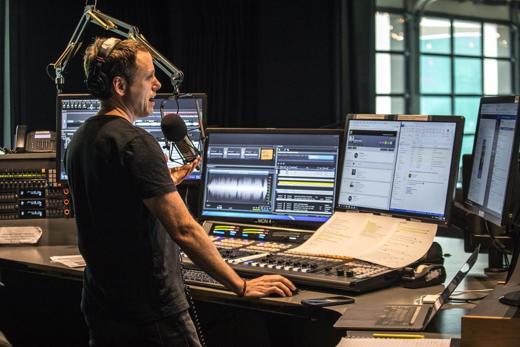 KEXP morning show host John Richards works in the main DJ booth during his show last month. (Steve Ringman / The Seattle Times)