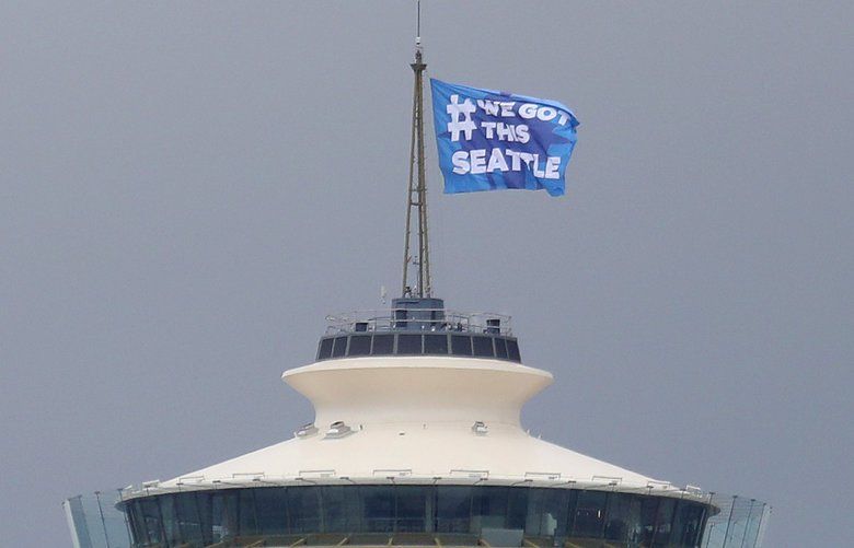 A flag that reads “# WE GOT THIS SEATTLE” was raised on the Space Needle roof, Thursday, March 26, 2020 in an effort to unite the city in battling the coronavirus.
 213472