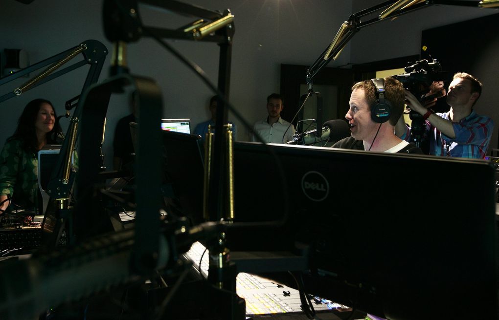 DJ Cheryl Waters talks on air with DJ John Richards in late 2015 during their first broadcasts inside the then-new KEXP studios at Seattle Center. Both say radio can play a powerful role in people’s lives, providing a sense of community and hope during somber times. (Erika Schultz / The Seattle Times)