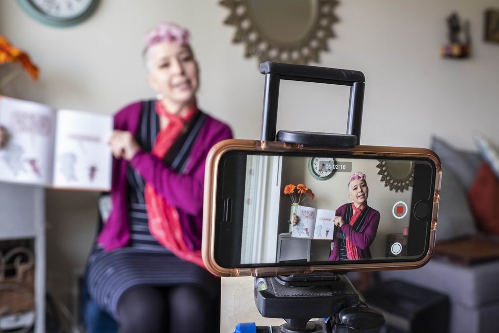 Laura Strand, visual arts teacher at Thurgood Marshall Elementary, set up an iPhone and microphone near the window of her apartment to create lessons, and records and edits to her laptop so she send out lessons to her students while schools are closed. (Dean Rutz / The Seattle Times)