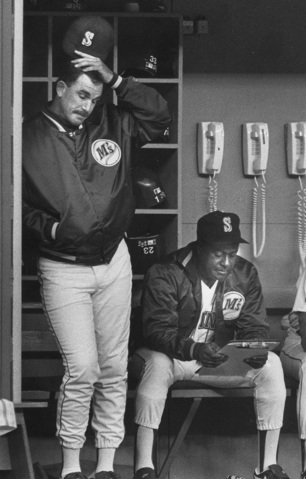 Mariners manager Bill Plummer watches a woeful team as hitting coach Gene Clines consults his clipboard. (Alan Berner / The Seattle Times, 1992 file)
