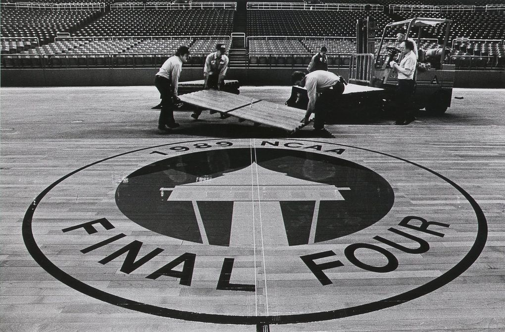 Workers install part of the hardwood floor for the Final Four at the Kingdome in 1989. (Jimi Lott / The Seattle Times)