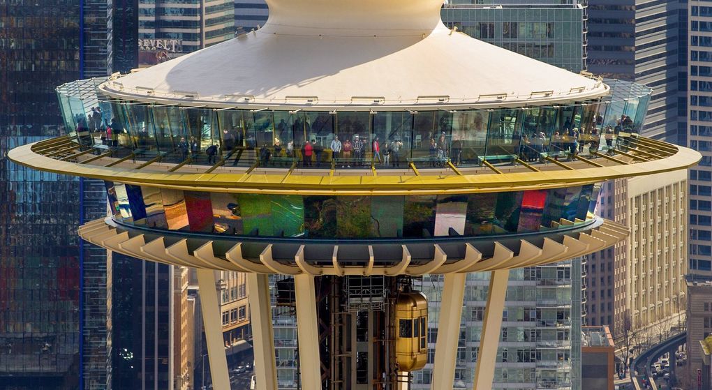 Visitors to the Space Needle’s observation deck are seen in this view from a helicopter passing by at 800 feet on March 15, 2019. (Mike Siegel / The Seattle Times)