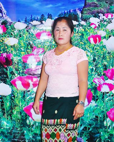 “Tojsiab Woman” by Pao Houa Her, 2015. Found image with opium floral backdrop from a website that connects Hmong American men with Hmong Laotian women. According to the artist, images like these are symbolic of feminine beauty, economic stability, and a vision of Laos before the American war. (Courtesy of Arts at King Street Station)