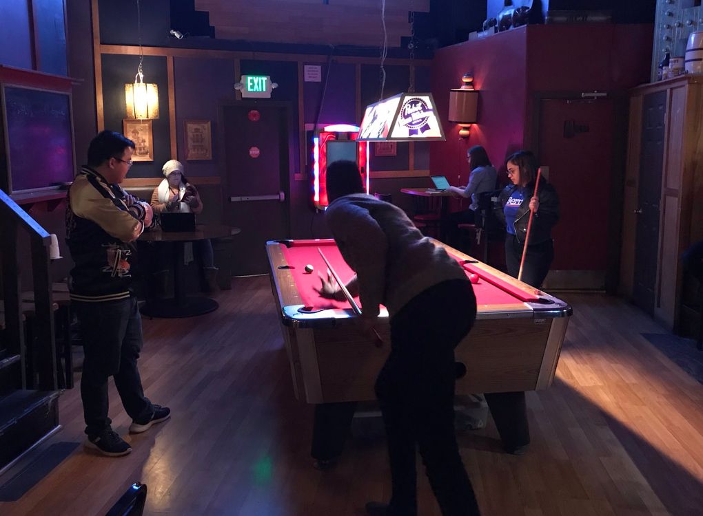 Bernie Sanders campaign staffer and volunteers play pool Tuesday night at a bar on Capitol Hill. (Dan Beekman / The Seattle Times)