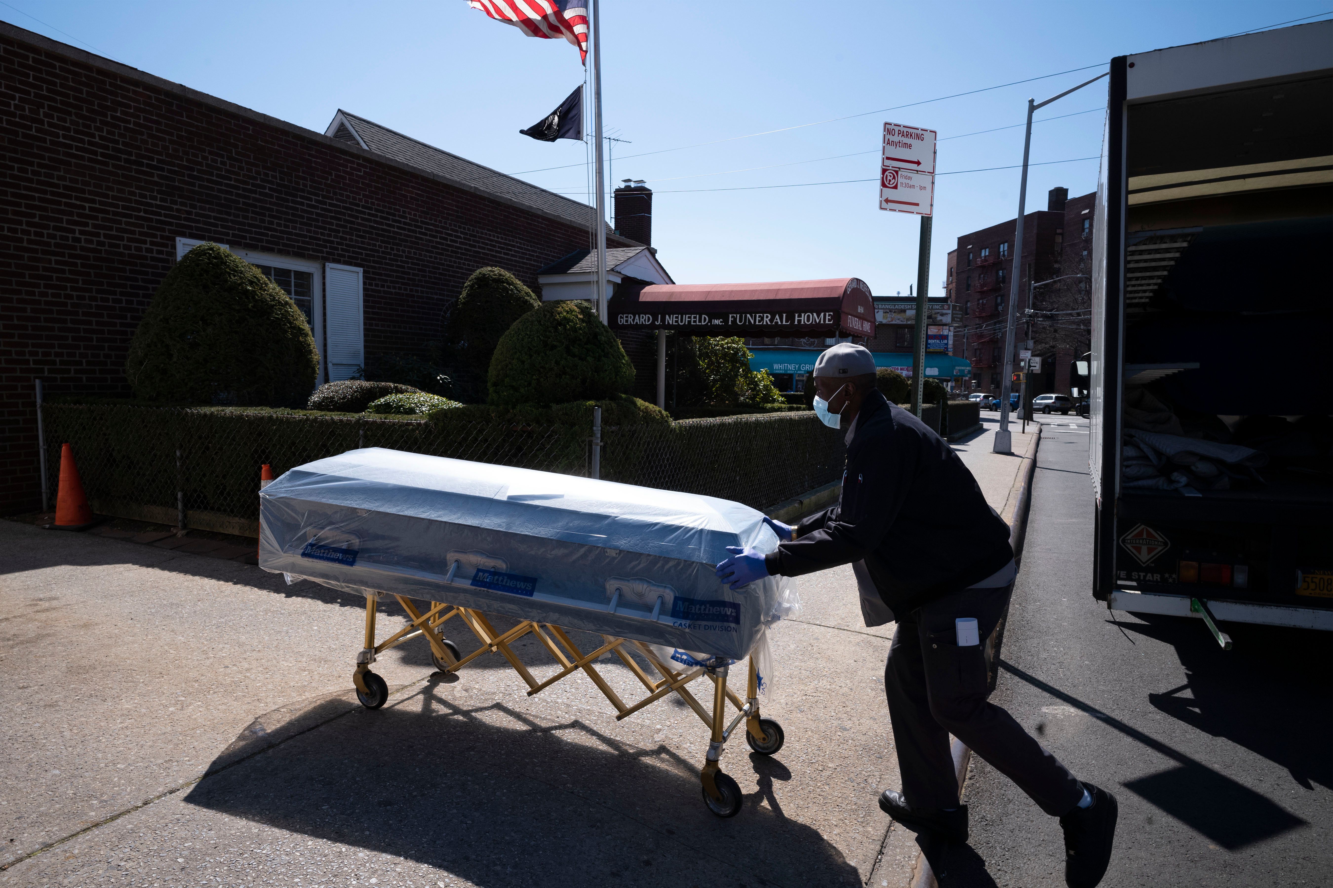 Closed caskets empty chairs at funeral home in virus center The