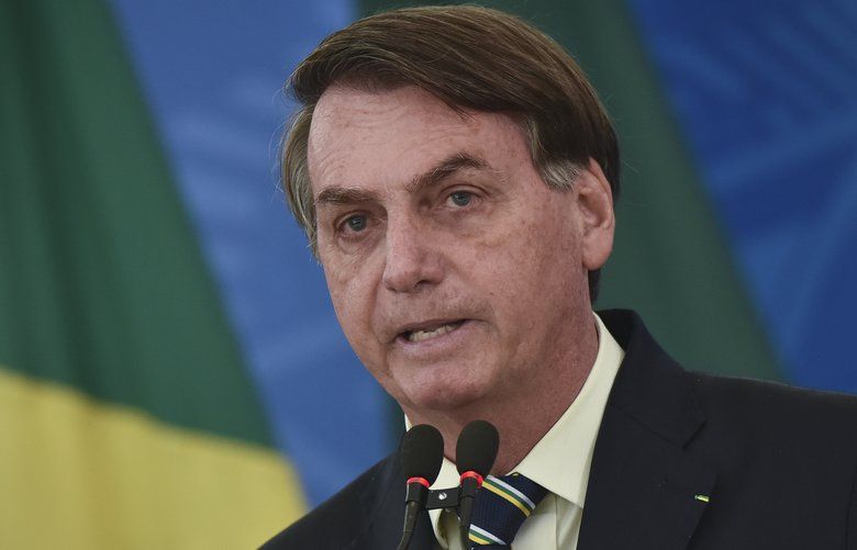 Brazil’s President Jair Bolsonaro speaks to journalists about the new coronavirus at Planalto presidential palace in Brasilia, Brazil, Friday, March 27, 2020. Even as the new coronavirus cases mount in Latin Americaâ€™s largest nation, Bolsonaro is calling the pandemic a momentary, minor problem and saying strong measures to contain it are unnecessary. (AP Photo/Andre Borges) XAP104 XAP104