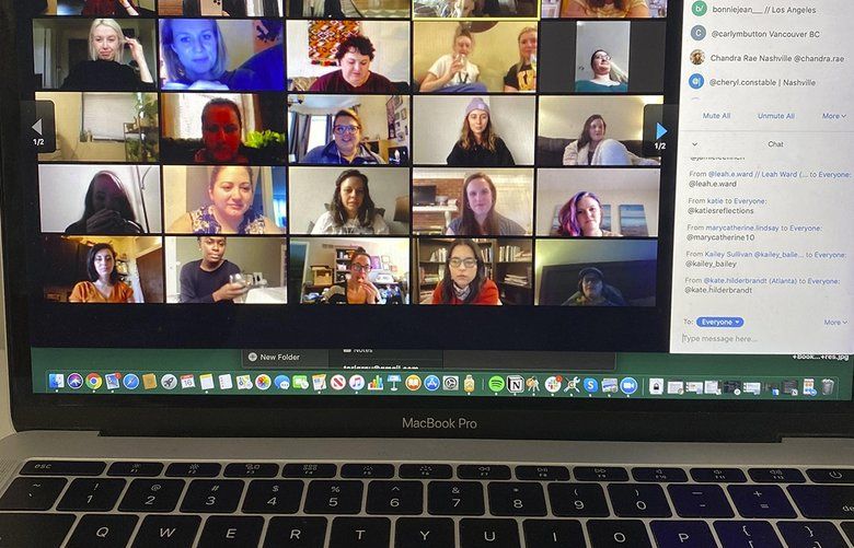 People gather on Zoom, a video conferencing app. Companies and friend groups across the U.S. are video chatting to keep spirits high. (Jamie Lee Finch/Columbia Daily Tribune/TNS) 1623862 1623862