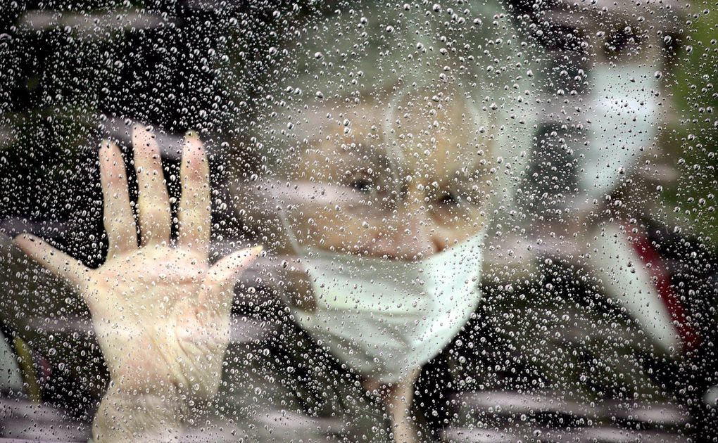 Judie Shape, 81, waves as she leaves the Life Care Center of Kirkland after recovering from the coronavirus she caught while there. (David Ryder / Special to The Seattle Times)