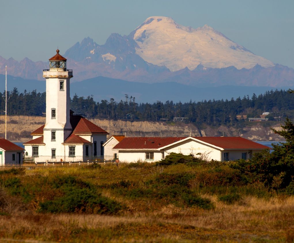 Mount Baker looms behind the Point Wilson Lighthouse near Fort Worden State Park in Port Townsend. (Mike Siegel / The Seattle Times)
